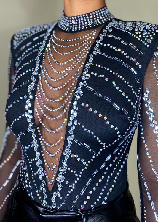 Nightclub outfit
Partywear bodysuit
Concert festival fashion
Special occasion top
Evening statement piece
Red carpet look
High-fashion event wear
Rhinestone-embellished bodysuit
Sheer mesh long sleeve top
High-neck crystal bodysuit
Deep V plunge bodysuit
Cut-out sheer design
Glamorous studded top
Sparkly beaded illusion bodysuit
Edgy and glamorous
Luxury high-fashion
Statement-making look
Bold and dazzling
Fashion-forward trend
Elegant yet daring
Sophisticated and sexy