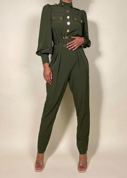 Chic workwear jumpsuit
Stylish office outfit
Smart-casual power dressing
Elegant dinner date fashion
Sophisticated fall/winter outfit
High-fashion street style
Modern military fashion
Professional yet trendy look
Stylish formal event attire
Statement jumpsuit for any occasion
Military-inspired jumpsuit
Gold button-detail jumpsuit
High-waisted structured jumpsuit
Utility fashion trend
Long sleeve jumpsuit with epaulets
Tailored jumpsuit with belted waist
Fashion-forward cargo jumpsuit
Pleated trouser