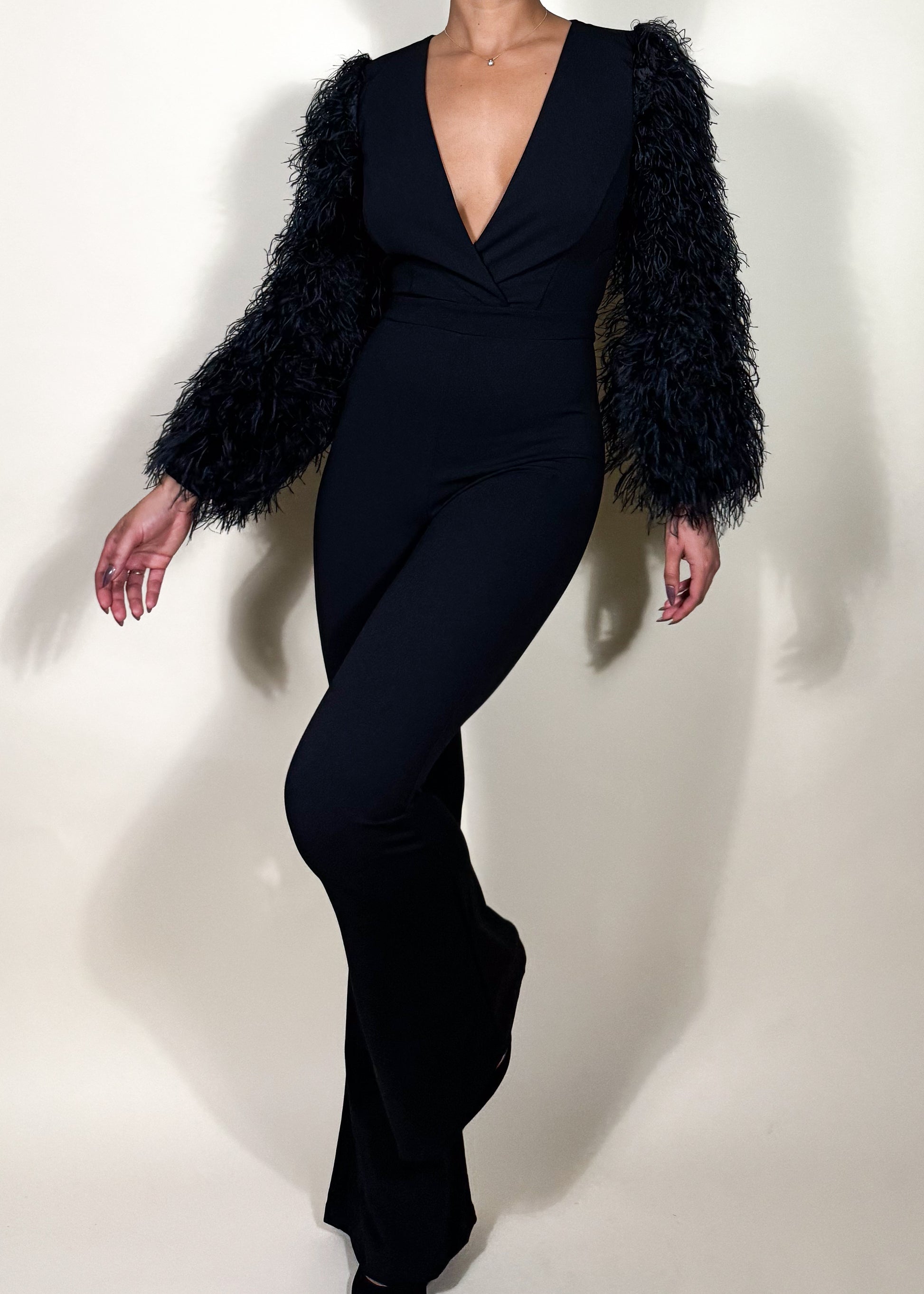 Elegant evening jumpsuit
Cocktail party outfit
Red carpet look
Date night fashion
Holiday party attire
Glamorous event outfit
Black-tie jumpsuit
Formal dinner look
Luxury fashion statement
Stylish night-out outfit
Black feather sleeve jumpsuit
Plunging V-neck jumpsuit
Statement sleeve fashion
Wide-leg fitted jumpsuit
Monochrome elegant outfit
Tailored women’s jumpsuit
Dramatic sleeve fashion
Sleek all-black ensemble
Trendy one-piece outfit
High-fashion jumpsuit
Bold and sophisticated
Modern luxury aesthetic