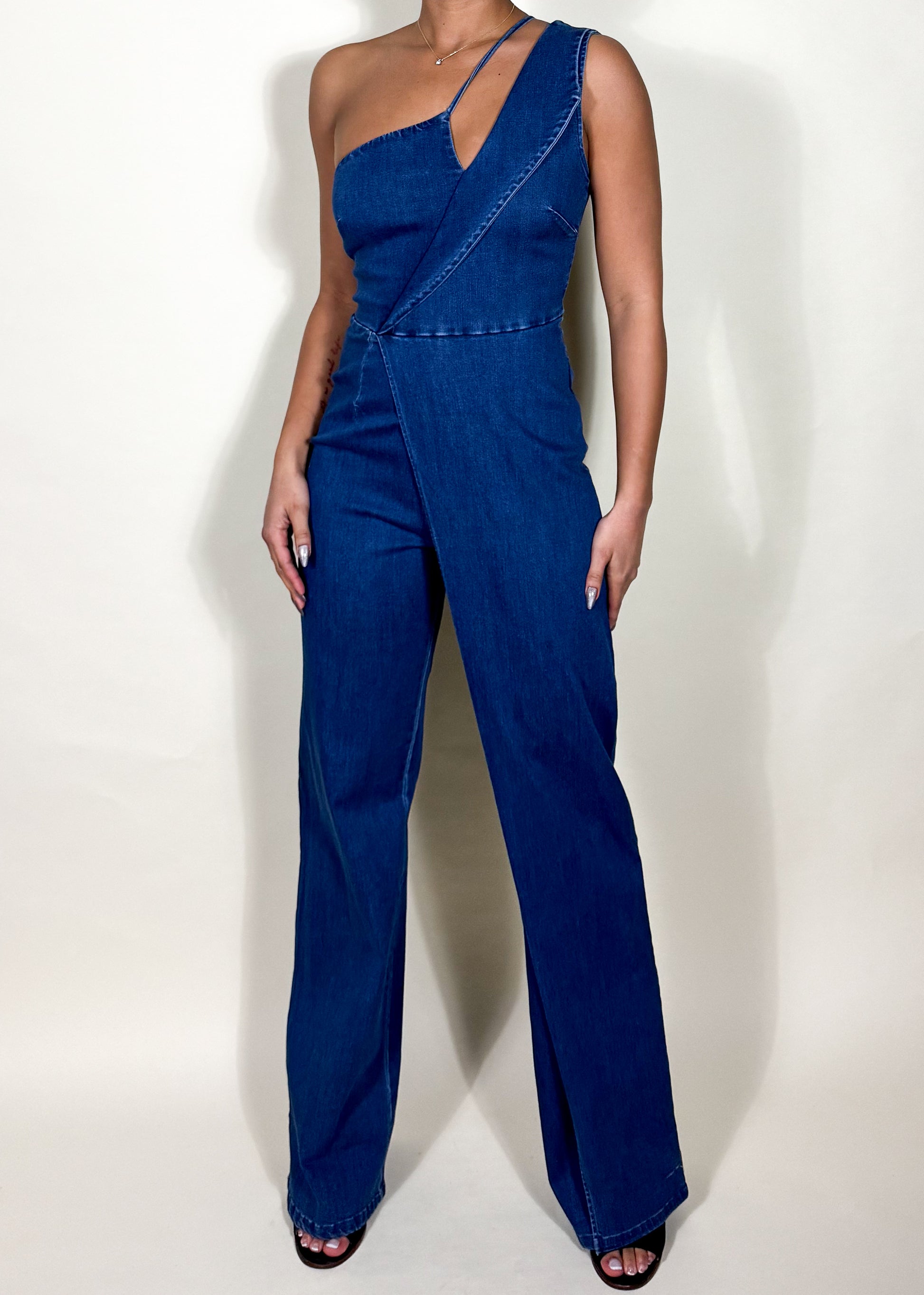 Casual chic outfit
Denim fashion statement
Trendy brunch outfit
Street style denim look
Night out fashion
Summer/fall fashion piece
Concert or festival outfit
Weekend casual wear
Fashion-forward event look
Contemporary casual wear
One-shoulder denim jumpsuit
Asymmetrical denim design
Modern denim romper
Statement wide-leg jumpsuit
Dark wash denim outfit
Tailored denim one-piece
Sleek and structured jumpsuit
Minimalist denim fashion
Unique cutout denim outfit
High-fashion denim wear
Chic and modern aesthetic
