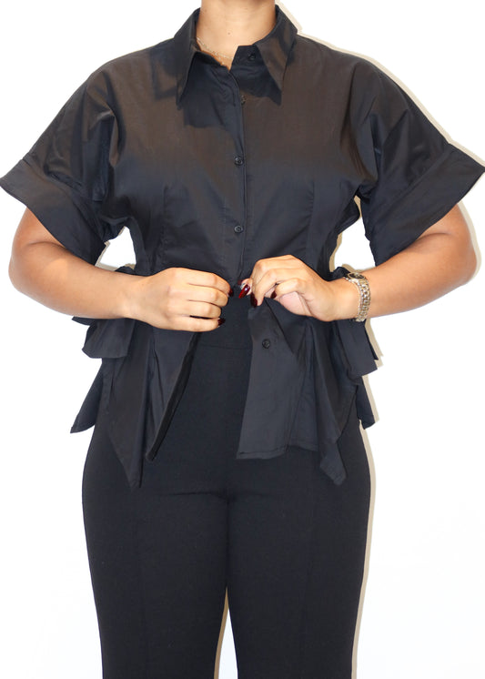 Workwear, Business casual, Office chic, Evening dinner, Smart casual, Formal event, Executive style, Professional attire, Stylish everyday wear, Button-up blouse, Short-sleeve collared shirt, Cinched waist detail, Side bow-tie accents, Asymmetrical hem, Structured silhouette, Tailored fit, Modern minimalist, Statement side ruffles, 
Black button-up blouse, Statement work blouse, Designer-inspired structured shirt, Elegant office top, Short-sleeve dress shirt for women, Unique business casual top, Asymmetric