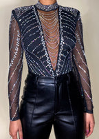 Nightclub outfit
Partywear bodysuit
Concert festival fashion
Special occasion top
Evening statement piece
Red carpet look
High-fashion event wear
Rhinestone-embellished bodysuit
Sheer mesh long sleeve top
High-neck crystal bodysuit
Deep V plunge bodysuit
Cut-out sheer design
Glamorous studded top
Sparkly beaded illusion bodysuit
Edgy and glamorous
Luxury high-fashion
Statement-making look
Bold and dazzling
Fashion-forward trend
Elegant yet daring
Sophisticated and sexy
