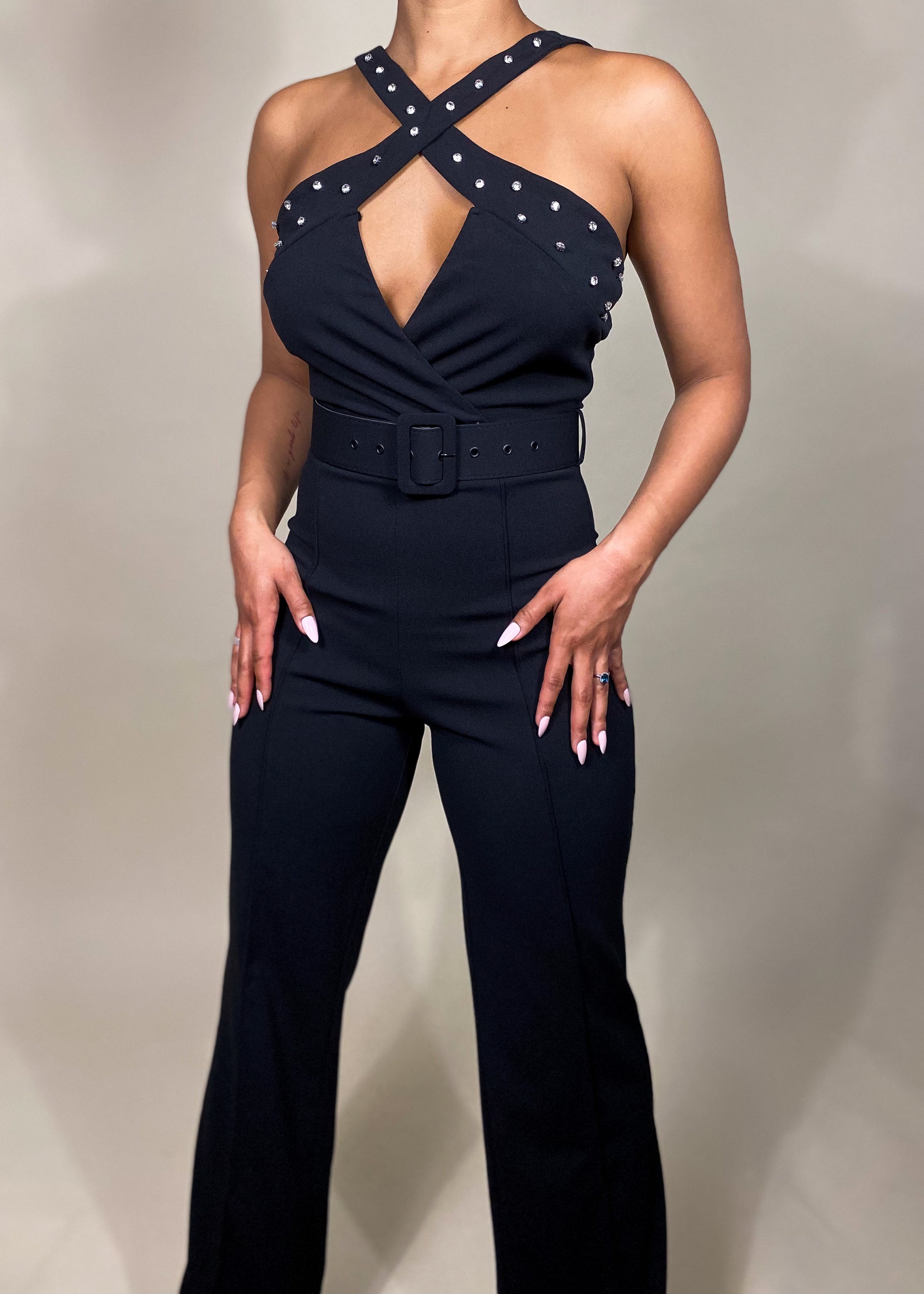 Elegant evening jumpsuit
Cocktail party outfit
Date night fashion
Formal event jumpsuit
Red carpet look
Wedding guest jumpsuit
Stylish partywear
Birthday celebration outfit
Chic clubwear outfit
Black tie event jumpsuit
Studded halter jumpsuit
Cross-neck jumpsuit
Belted waist jumpsuit
Wide-leg jumpsuit
Sleeveless evening jumpsuit
High-waisted jumpsuit
Tailored fit jumpsuit
Statement fashion piece
Luxury fashion jumpsuit
Glamorous black jumpsuit
Modern edgy fashion
Sophisticated yet bold
Sexy yet elegant outf