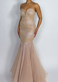 Wedding guest evening gown
Luxury prom night dress
Red carpet formal dress
Gala and black-tie event gown
Pageant and competition dress
Sheer ruched bodice gown
Floor-length mermaid silhouette dress
Strapless sweetheart neckline gown
Flowing tulle bottom formal dress
Figure-flattering luxury dress
Nude mermaid evening gown
Strapless sweetheart dress
Elegant tulle formal dress
Sparkly ruched bodycon gown
Glamorous fitted prom dress