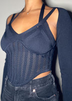  Night out, Clubwear, Party outfit, Concert look, Date night, Fashion-forward event, Street style, Trendy evening wear, Corset-inspired knit top, Sheer mesh details, Strappy shoulder design, Long-sleeve fitted silhouette, Sculpting ribbed fabric, Asymmetrical cut, Bustier-style bodice, Bodycon fit, Strappy long sleeve corset top, Mesh panel knitwear, Bustier-style fashion top, Trendy going-out top, Sexy sculpted knitwear, Edgy night-out outfit, High-fashion ribbed top, Statement sheer bodice, Clubwear knit 