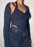  Night out, Clubwear, Party outfit, Concert look, Date night, Fashion-forward event, Street style, Trendy evening wear, Corset-inspired knit top, Sheer mesh details, Strappy shoulder design, Long-sleeve fitted silhouette, Sculpting ribbed fabric, Asymmetrical cut, Bustier-style bodice, Bodycon fit, Strappy long sleeve corset top, Mesh panel knitwear, Bustier-style fashion top, Trendy going-out top, Sexy sculpted knitwear, Edgy night-out outfit, High-fashion ribbed top, Statement sheer bodice, Clubwear knit 