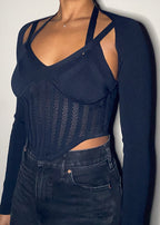  Night out, Clubwear, Party outfit, Concert look, Date night, Fashion-forward event, Street style, Trendy evening wear, Corset-inspired knit top, Sheer mesh details, Strappy shoulder design, Long-sleeve fitted silhouette, Sculpting ribbed fabric, Asymmetrical cut, Bustier-style bodice, Bodycon fit, Strappy long sleeve corset top, Mesh panel knitwear, Bustier-style fashion top, Trendy going-out top, Sexy sculpted knitwear, Edgy night-out outfit, High-fashion ribbed top, Statement sheer bodice, Clubwear knit 
