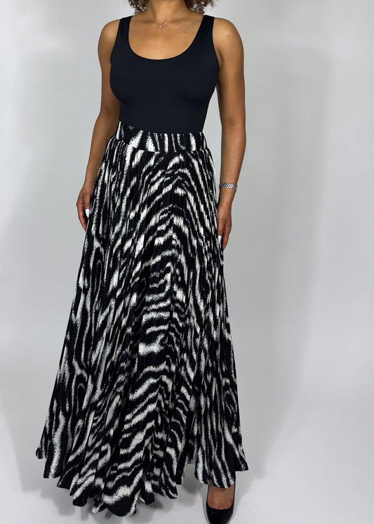Zebra print skirt
Animal print maxi skirt
High-waisted full skirt
Flowy A-line skirt
Black and white statement skirt
Bold patterned skirt
Long pleated skirt
Wide hem maxi skirt
Boho chic
Glamorous fashion
Edgy elegance
Statement fashion
Fashion-forward outfit
Retro-inspired style
Sophisticated and bold
High-waisted dramatic skirt
Timeless monochrome 