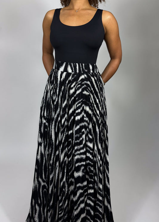 Zebra print skirt
Animal print maxi skirt
High-waisted full skirt
Flowy A-line skirt
Black and white statement skirt
Bold patterned skirt
Long pleated skirt
Wide hem maxi skirt
Boho chic
Glamorous fashion
Edgy elegance
Statement fashion
Fashion-forward outfit
Retro-inspired style
Sophisticated and bold
High-waisted dramatic skirt
Timeless monochrome 
