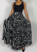 Zebra print skirt
Animal print maxi skirt
High-waisted full skirt
Flowy A-line skirt
Black and white statement skirt
Bold patterned skirt
Long pleated skirt
Wide hem maxi skirt
Boho chic
Glamorous fashion
Edgy elegance
Statement fashion
Fashion-forward outfit
Retro-inspired style
Sophisticated and bold
High-waisted dramatic skirt
Timeless monochrome 