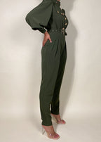 Chic workwear jumpsuit
Stylish office outfit
Smart-casual power dressing
Elegant dinner date fashion
Sophisticated fall/winter outfit
High-fashion street style
Modern military fashion
Professional yet trendy look
Stylish formal event attire
Statement jumpsuit for any occasion
Military-inspired jumpsuit
Gold button-detail jumpsuit
High-waisted structured jumpsuit
Utility fashion trend
Long sleeve jumpsuit with epaulets
Tailored jumpsuit with belted waist
Fashion-forward cargo jumpsuit
Pleated trouser