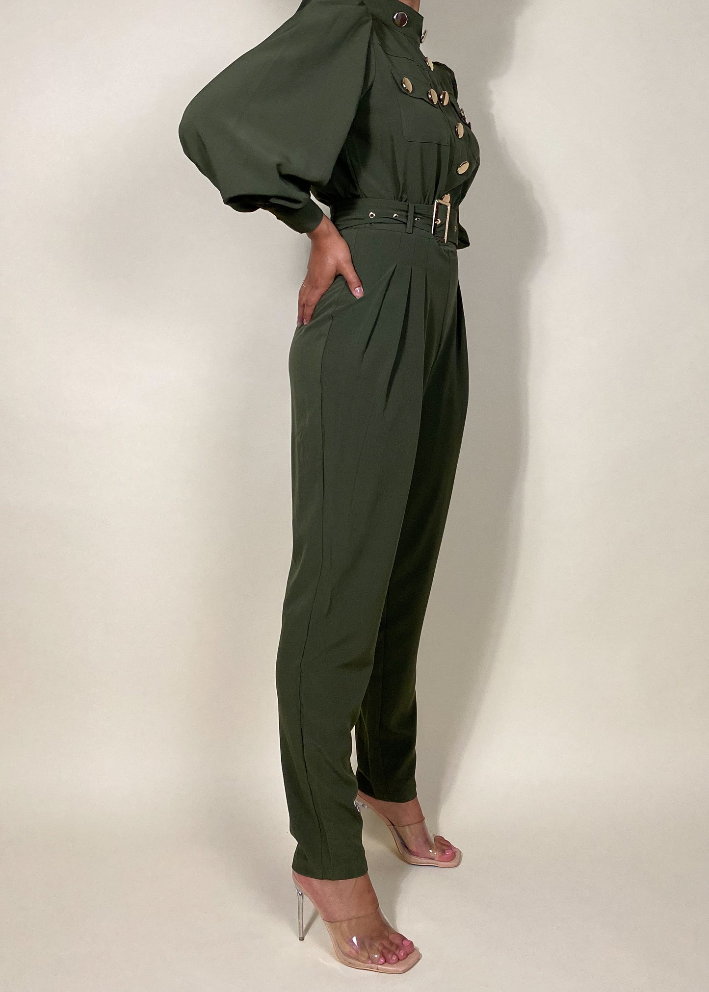 Chic workwear jumpsuit
Stylish office outfit
Smart-casual power dressing
Elegant dinner date fashion
Sophisticated fall/winter outfit
High-fashion street style
Modern military fashion
Professional yet trendy look
Stylish formal event attire
Statement jumpsuit for any occasion
Military-inspired jumpsuit
Gold button-detail jumpsuit
High-waisted structured jumpsuit
Utility fashion trend
Long sleeve jumpsuit with epaulets
Tailored jumpsuit with belted waist
Fashion-forward cargo jumpsuit
Pleated trouser