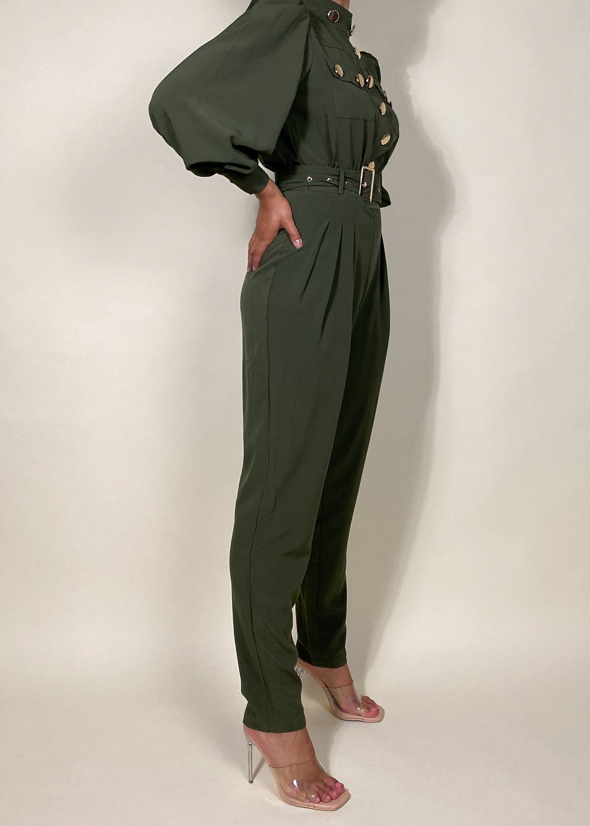 Chic workwear jumpsuit
Stylish office outfit
Smart-casual power dressing
Elegant dinner date fashion
Sophisticated fall/winter outfit
High-fashion street style
Modern military fashion
Professional yet trendy look
Stylish formal event attire
Statement jumpsuit for any occasion
Military-inspired jumpsuit
Gold button-detail jumpsuit
High-waisted structured jumpsuit
Utility fashion trend
Long sleeve jumpsuit with epaulets
Tailored jumpsuit with belted waist
Fashion-forward cargo jumpsuit
Pleated trouser
