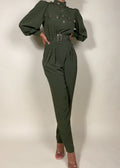 Chic workwear jumpsuit
Stylish office outfit
Smart-casual power dressing
Elegant dinner date fashion
Sophisticated fall/winter outfit
High-fashion street style
Modern military fashion
Professional yet trendy look
Stylish formal event attire
Statement jumpsuit for any occasion
Military-inspired jumpsuit
Gold button-detail jumpsuit
High-waisted structured jumpsuit
Utility fashion trend
Long sleeve jumpsuit with epaulets
Tailored jumpsuit with belted waist
Fashion-forward cargo jumpsuit
Pleated trouser
