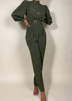 Chic workwear jumpsuit
Stylish office outfit
Smart-casual power dressing
Elegant dinner date fashion
Sophisticated fall/winter outfit
High-fashion street style
Modern military fashion
Professional yet trendy look
Stylish formal event attire
Statement jumpsuit for any occasion
Military-inspired jumpsuit
Gold button-detail jumpsuit
High-waisted structured jumpsuit
Utility fashion trend
Long sleeve jumpsuit with epaulets
Tailored jumpsuit with belted waist
Fashion-forward cargo jumpsuit
Pleated trouser