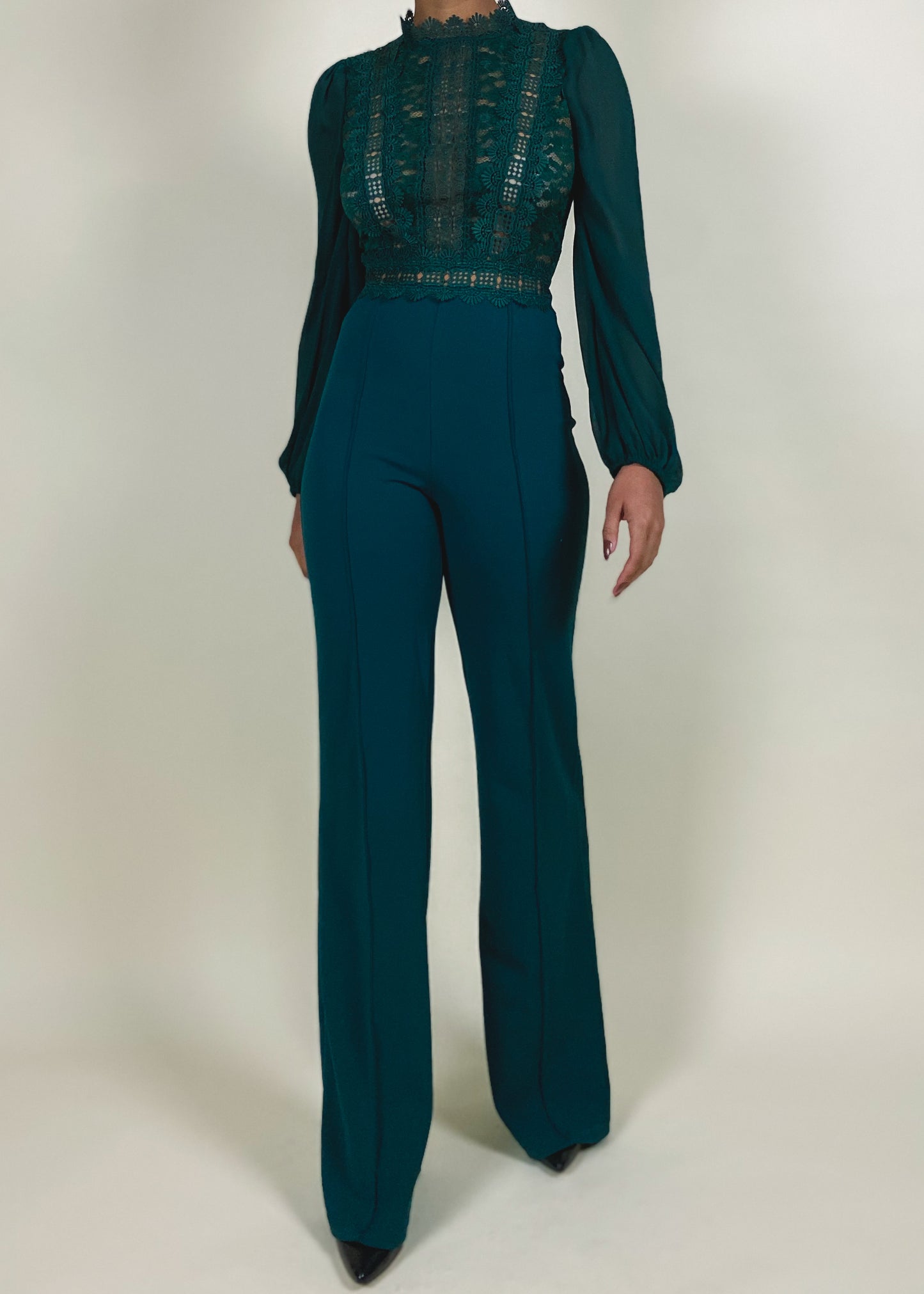 Wedding guest outfit idea
Office-to-evening transition look
Formal jumpsuit for special occasions
Elegant workwear for women
Statement outfit for upscale events
Sheer lace bodice with high neckline
Long puffed sleeves with delicate finish
High-waisted flared pants
Structured yet flowy jumpsuit
Tailored fit with feminine lace accents
Elegant teal jumpsuit
Chic one-piece outfit for women
Sophisticated evening wear
Lace detail jumpsuit
Timeless fashion statement