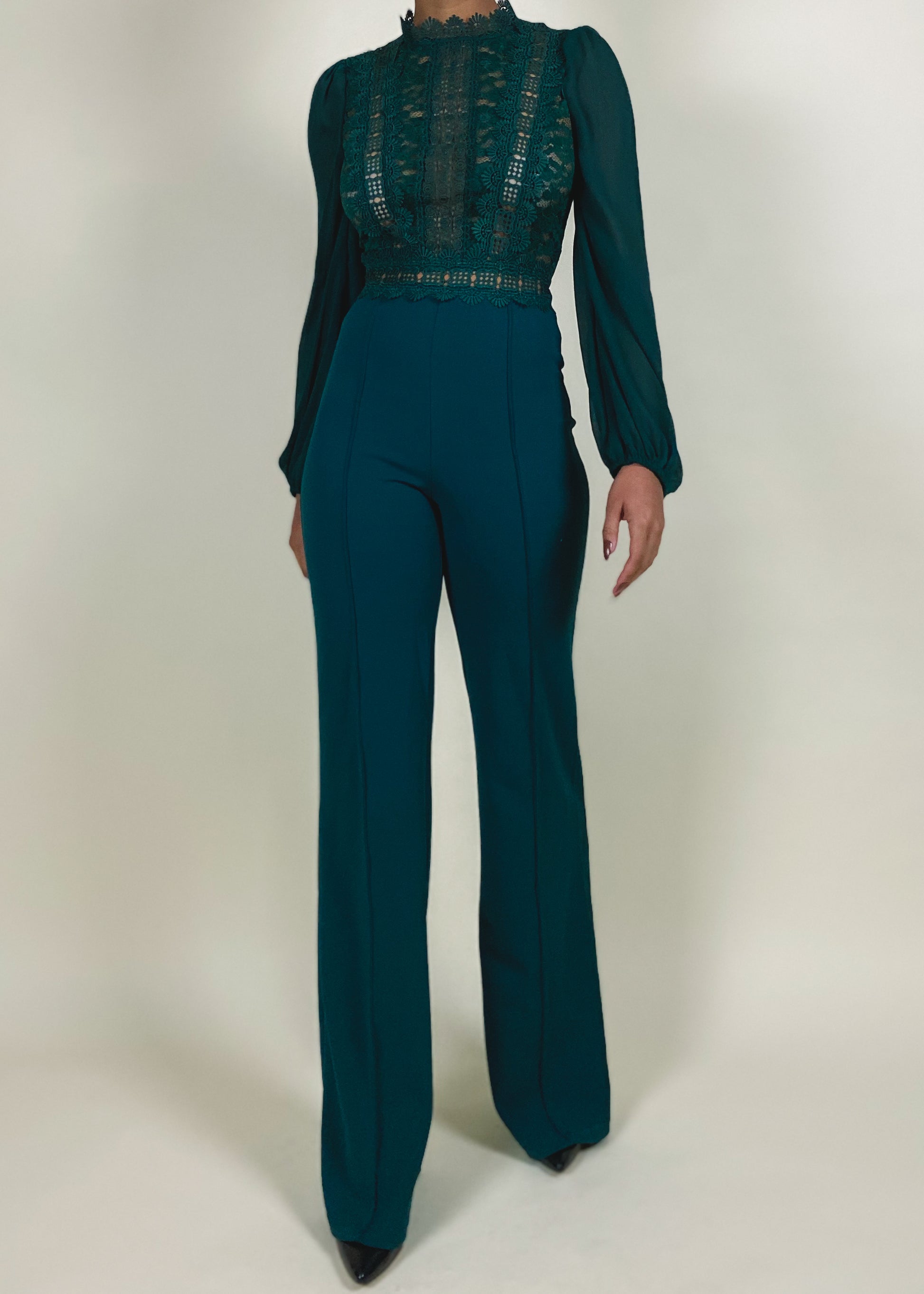 Wedding guest outfit idea
Office-to-evening transition look
Formal jumpsuit for special occasions
Elegant workwear for women
Statement outfit for upscale events
Sheer lace bodice with high neckline
Long puffed sleeves with delicate finish
High-waisted flared pants
Structured yet flowy jumpsuit
Tailored fit with feminine lace accents
Elegant teal jumpsuit
Chic one-piece outfit for women
Sophisticated evening wear
Lace detail jumpsuit
Timeless fashion statement
